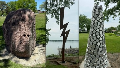 Outdoor triptych: left—carved stone face; center—tall lightning-bolt sculpture by the lake; right—tower of stacked cubes.